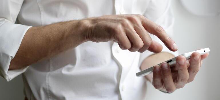 person looking at the phone about how to help elderly people move to California