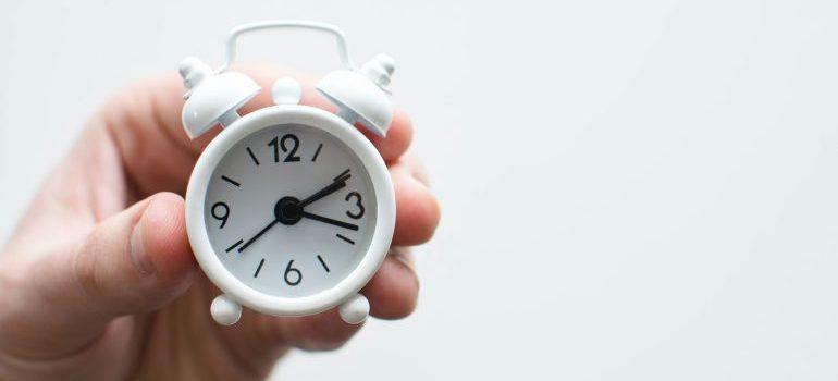 person holding a clock