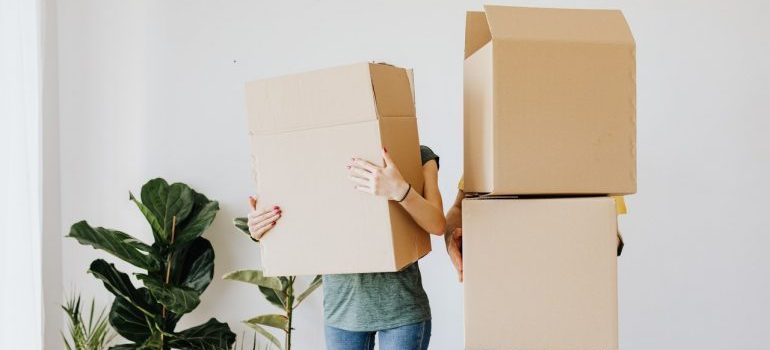 Couple holding boxes