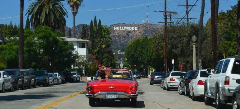 Person in red car driving to one of the places to see after moving to LA