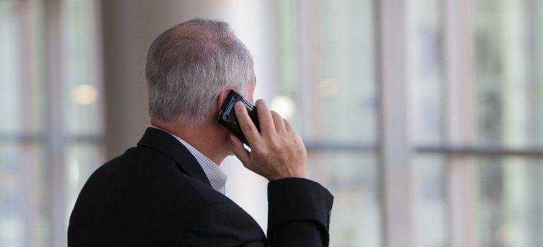 An elderly man talking on the phone